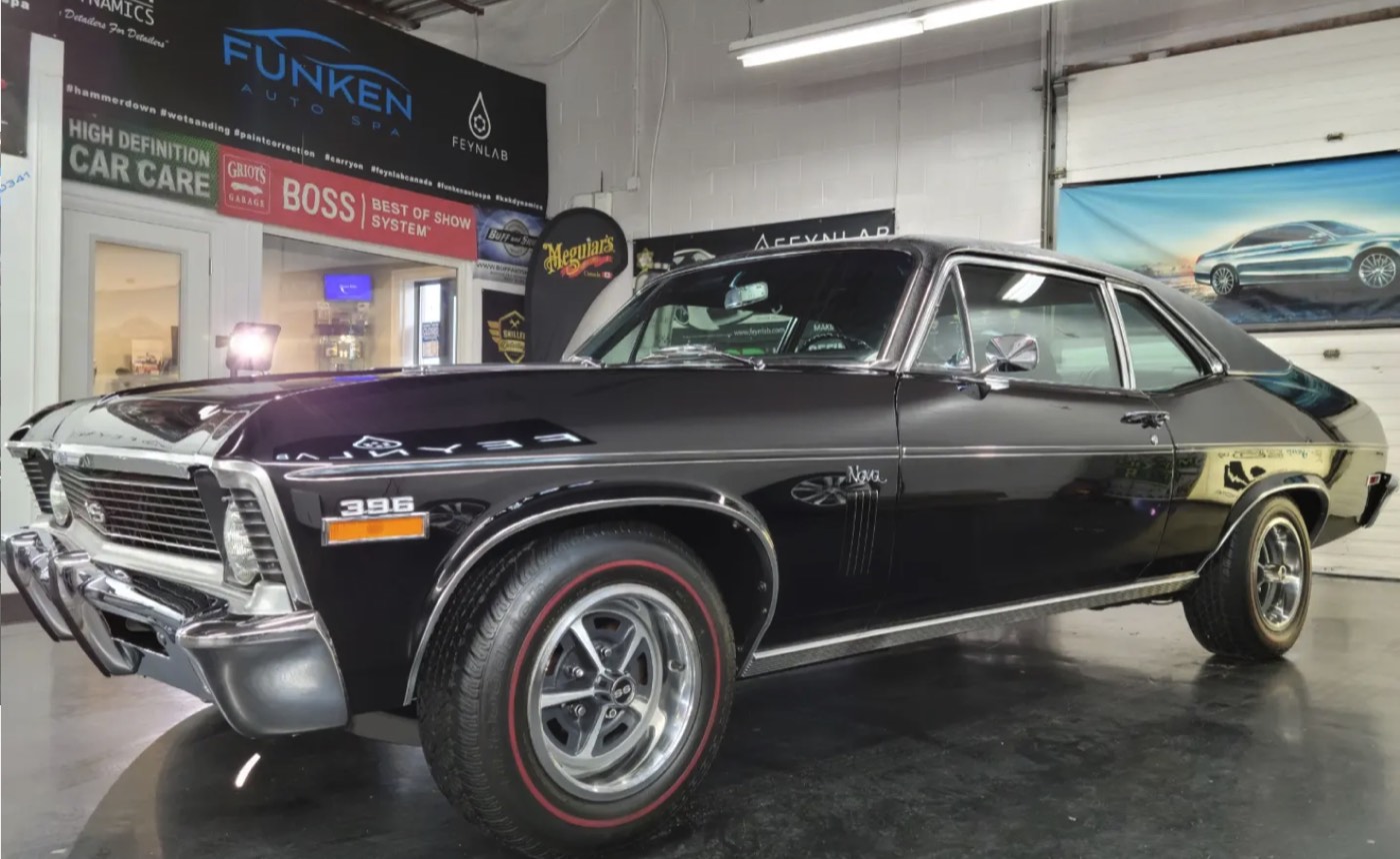 Black Chevrolet Nova SS 396 reflecting the shop lighting at Funken Auto Spa, Guelph